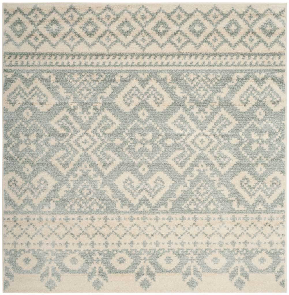 Square ivory and slate rug centers softly colored medallions between ornate geometric borders.