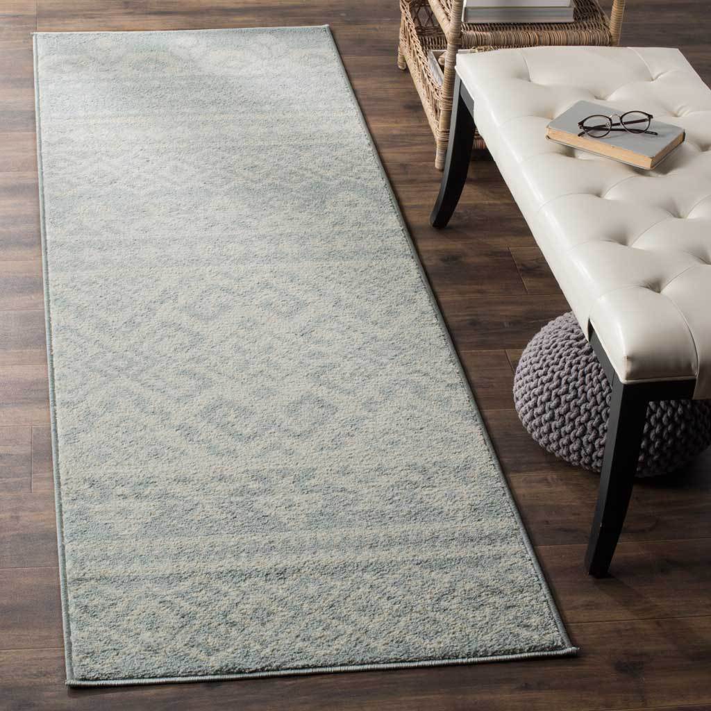 Muted slate and ivory tones lend this runner a soft texture and subtle pattern