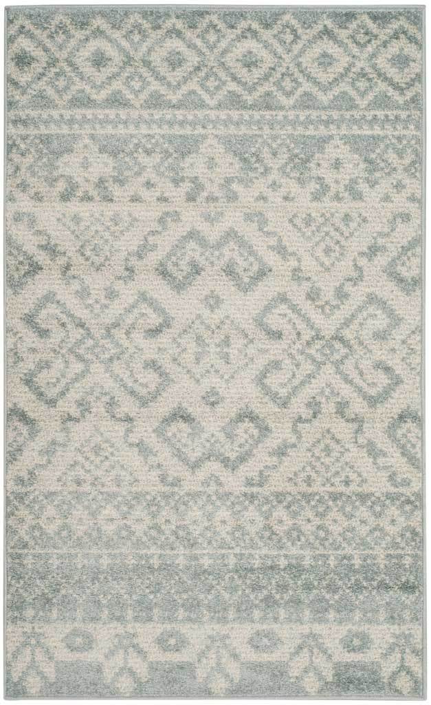 Slate and ivory rug balances a central diamond medallion with delicate decorative bands.