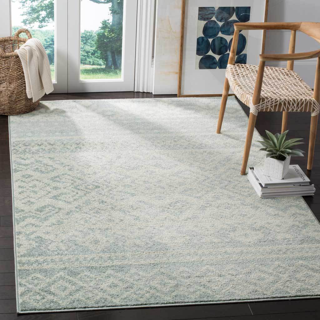 Slate and ivory rug adds a gentle wash of pattern beneath natural wood furnishings.