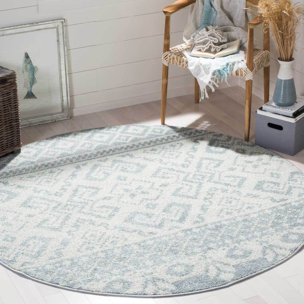 Airy slate and ivory motifs add a relaxed geometric accent to this round rug.