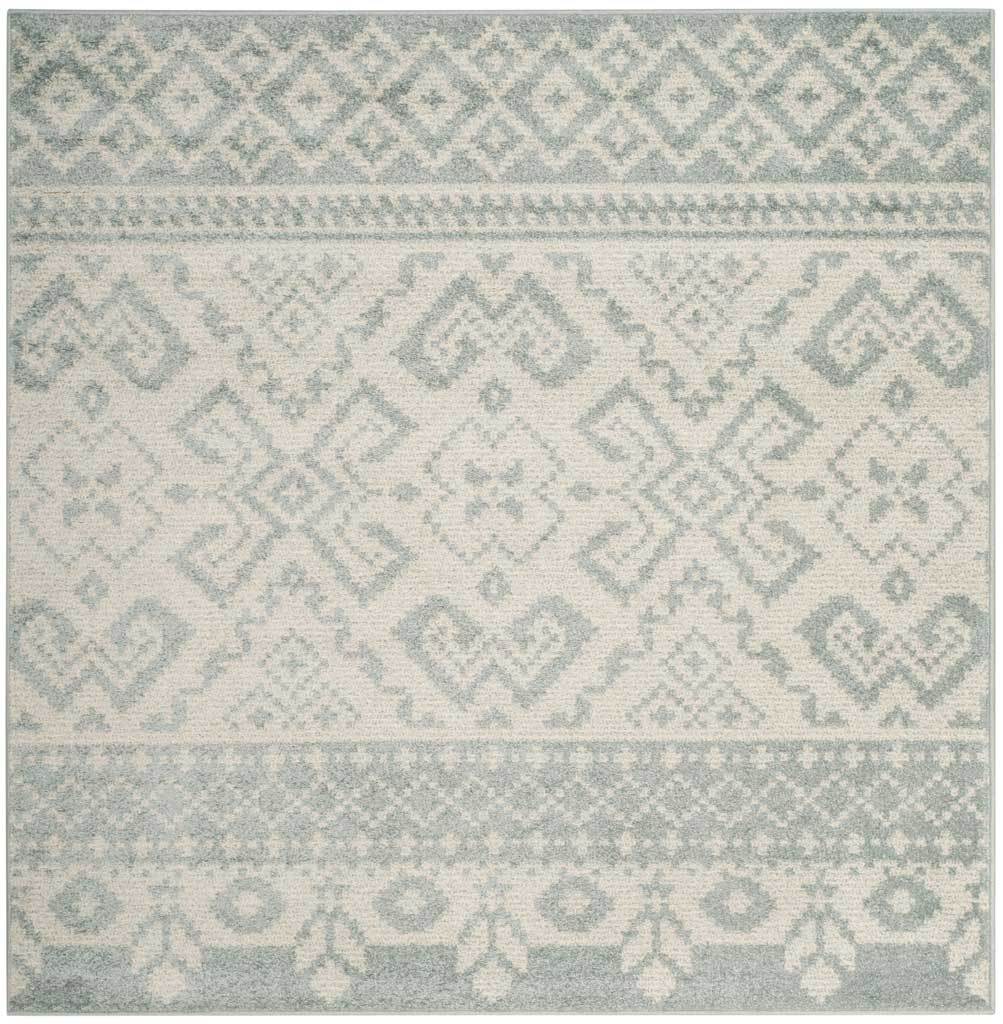 Square slate and ivory rug pairs understated medallions with diamond and floral borders.