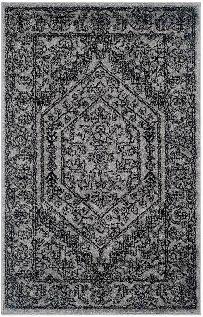 Compact silver rug features a dark hexagonal medallion and richly distressed florals.