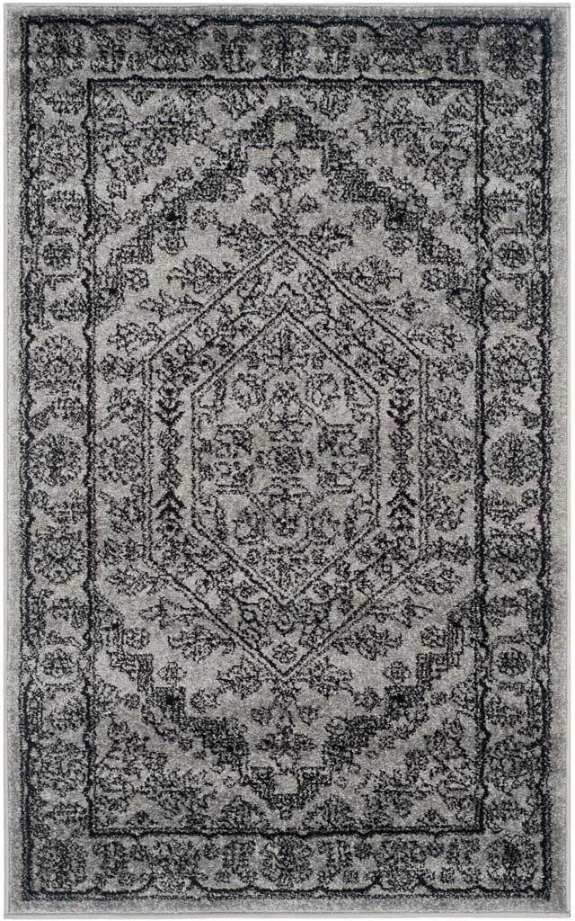 Small silver and black rug is densely patterned with floral scrolls and geometric accents.