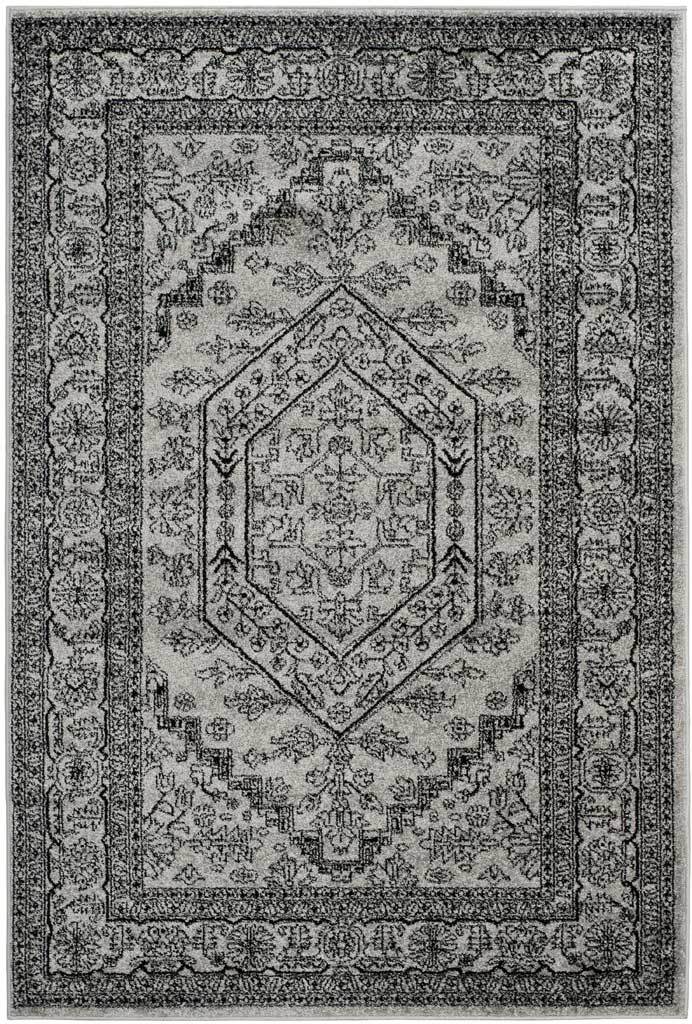 Silver area rug with dark botanical ornament and a crisply outlined medallion.