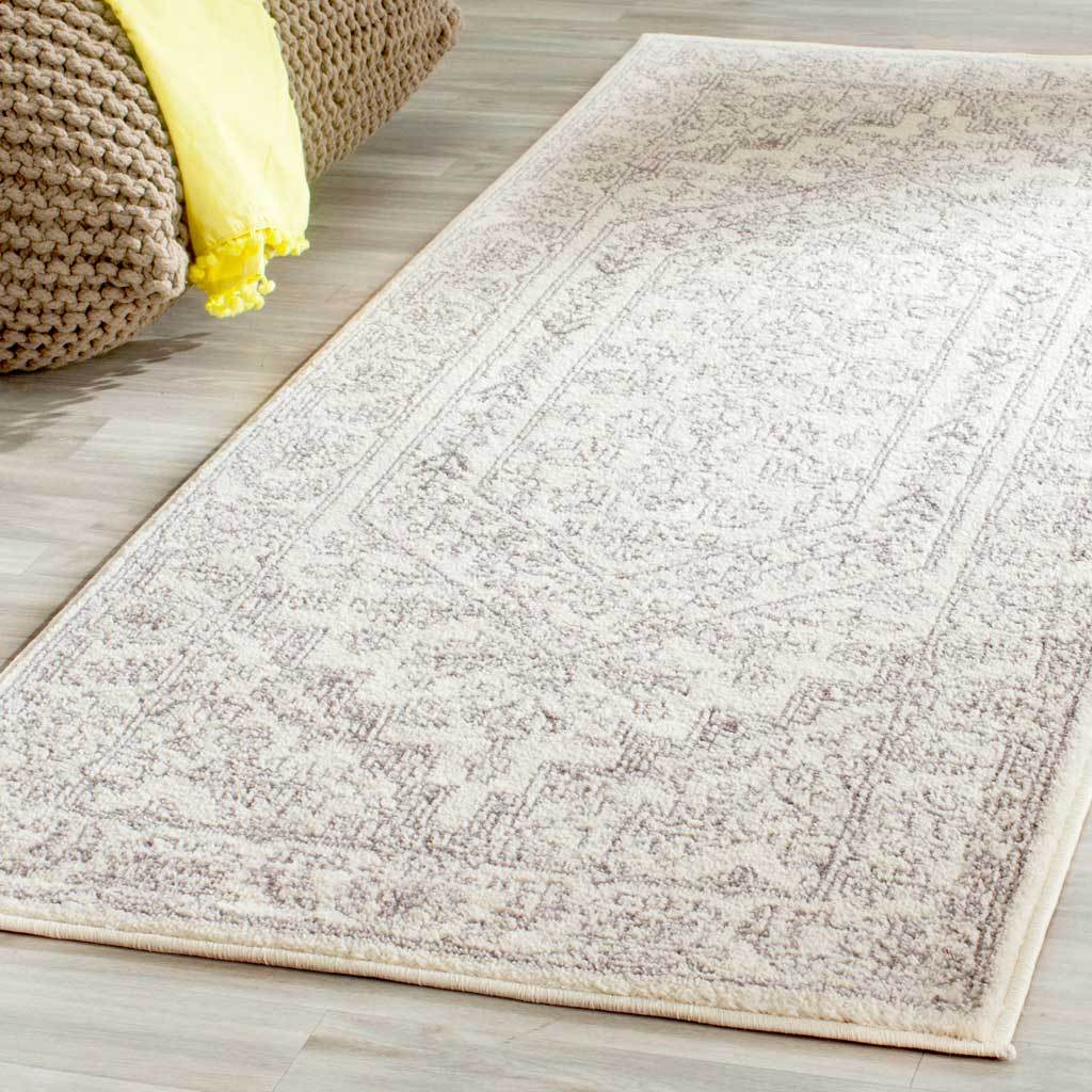 Subtle silver motifs and a central medallion lend this ivory runner vintage charm
