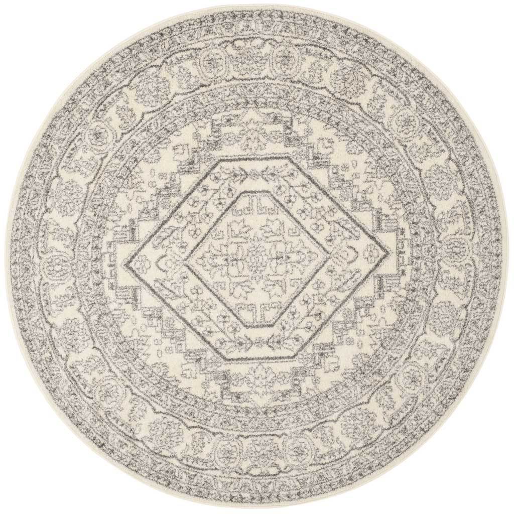 Ivory and silver round rug with a bold diamond medallion and distressed detailing