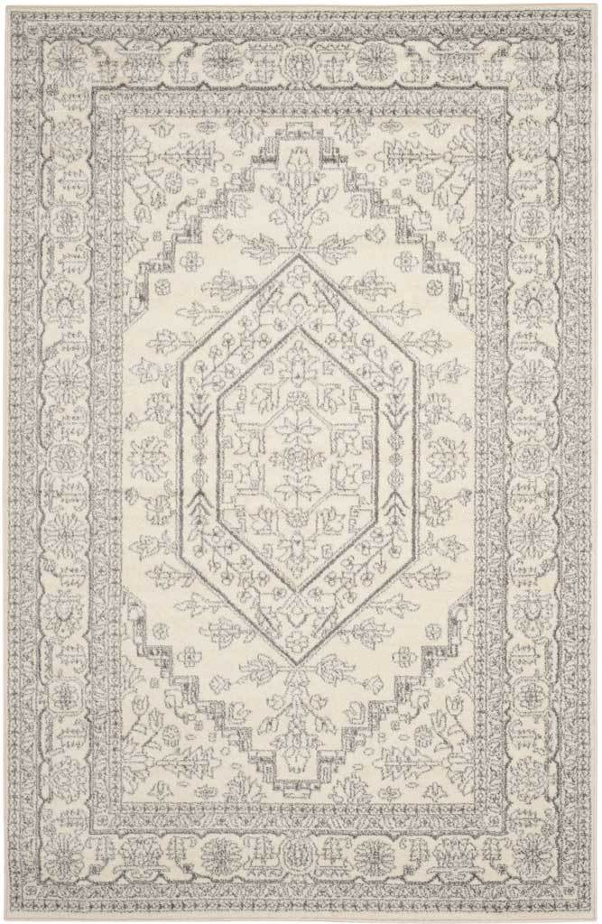 Ivory rug with a subtle silver medallion and patterned border for gentle contrast.
