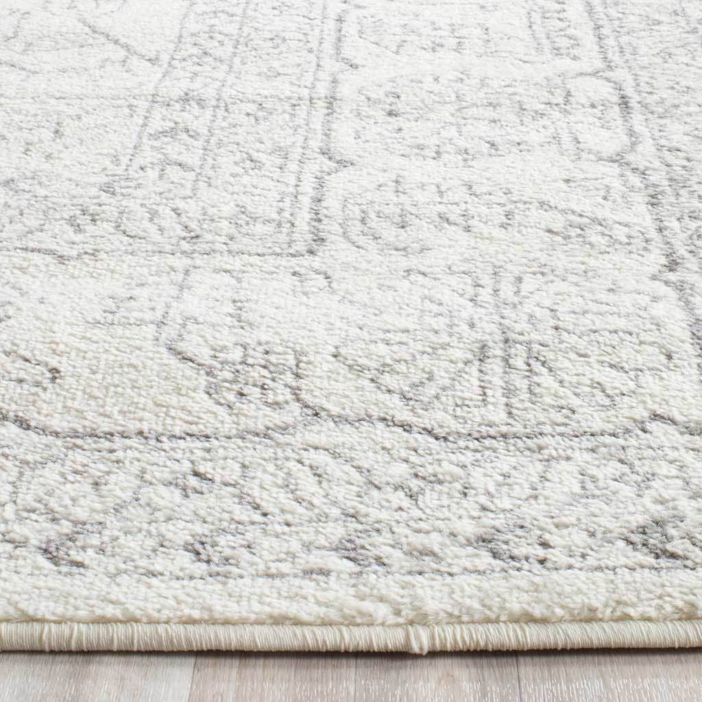 Soft ivory pile shows faint silver patterning above a neatly bound edge.