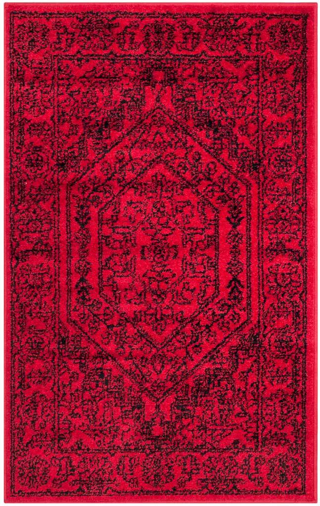 Small red and black rug packs rich floral tracery around a dramatic hexagonal center.