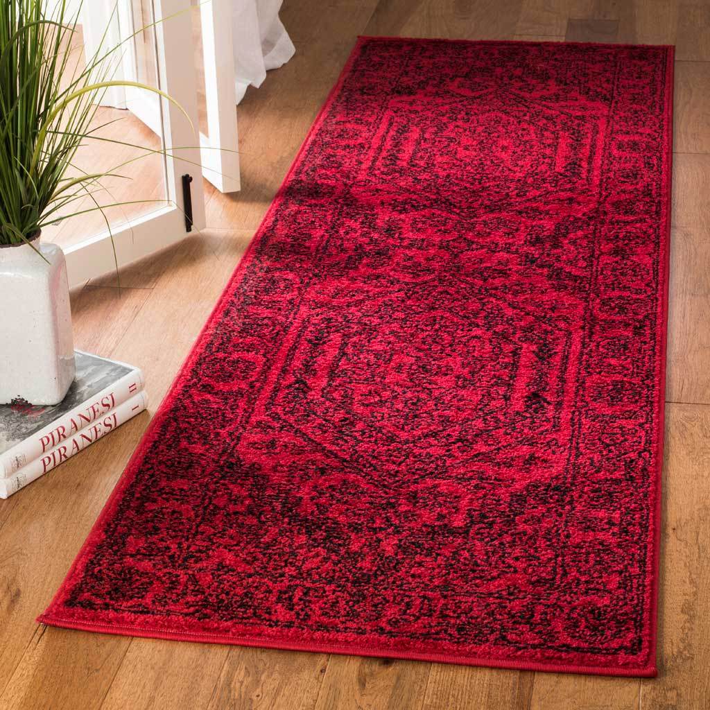 Bold red runner with dense black floral detailing and two framed medallions