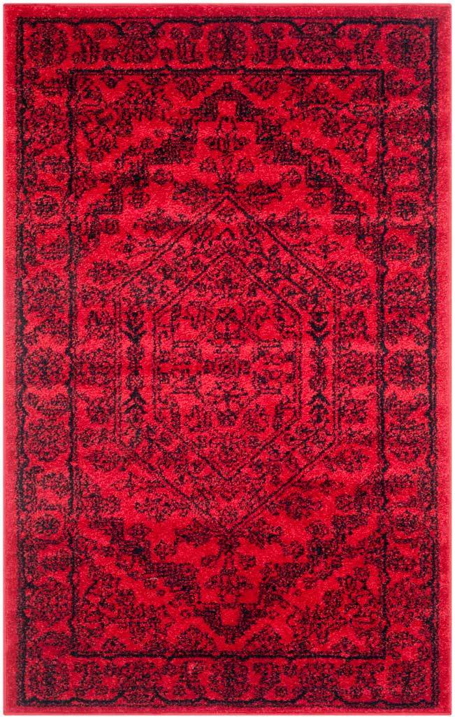 Compact red area rug carries black vintage-style florals around its central motif.