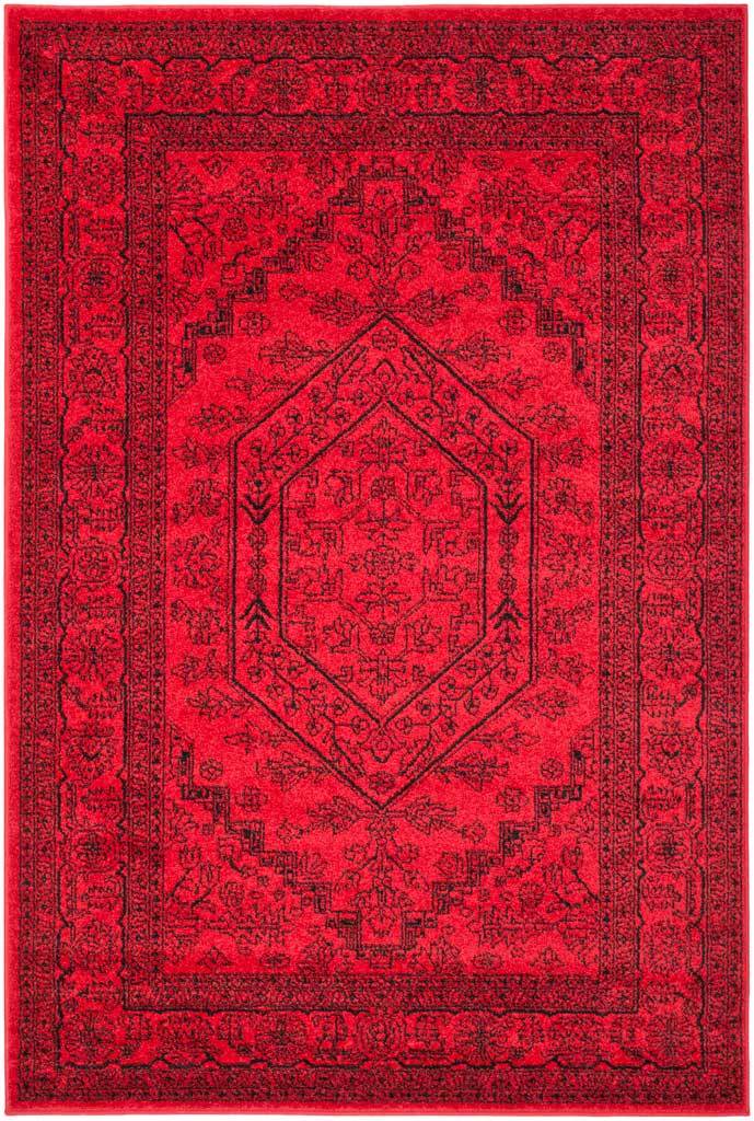 Red rug balances an ornate black medallion with densely patterned floral edges.