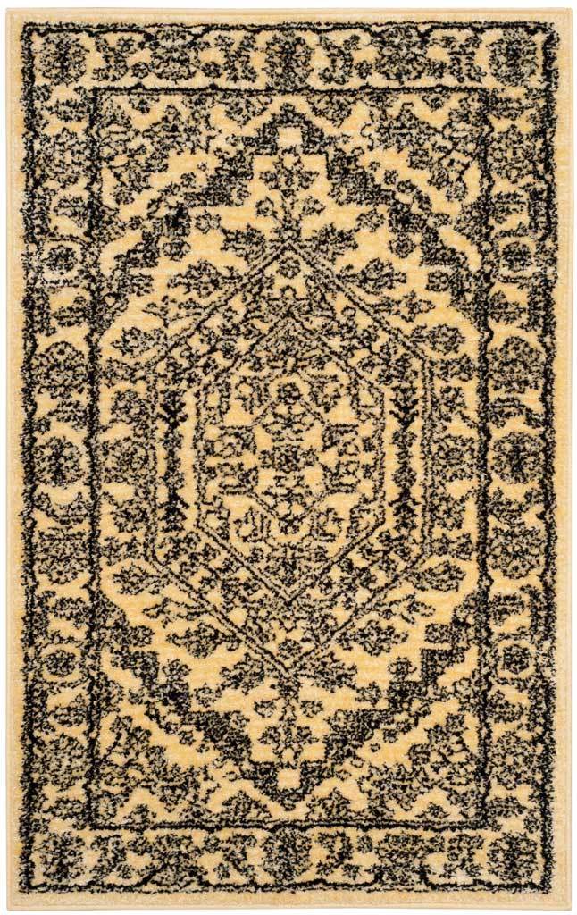 Gold rug with dense black floral scrollwork surrounding a vintage-style medallion.