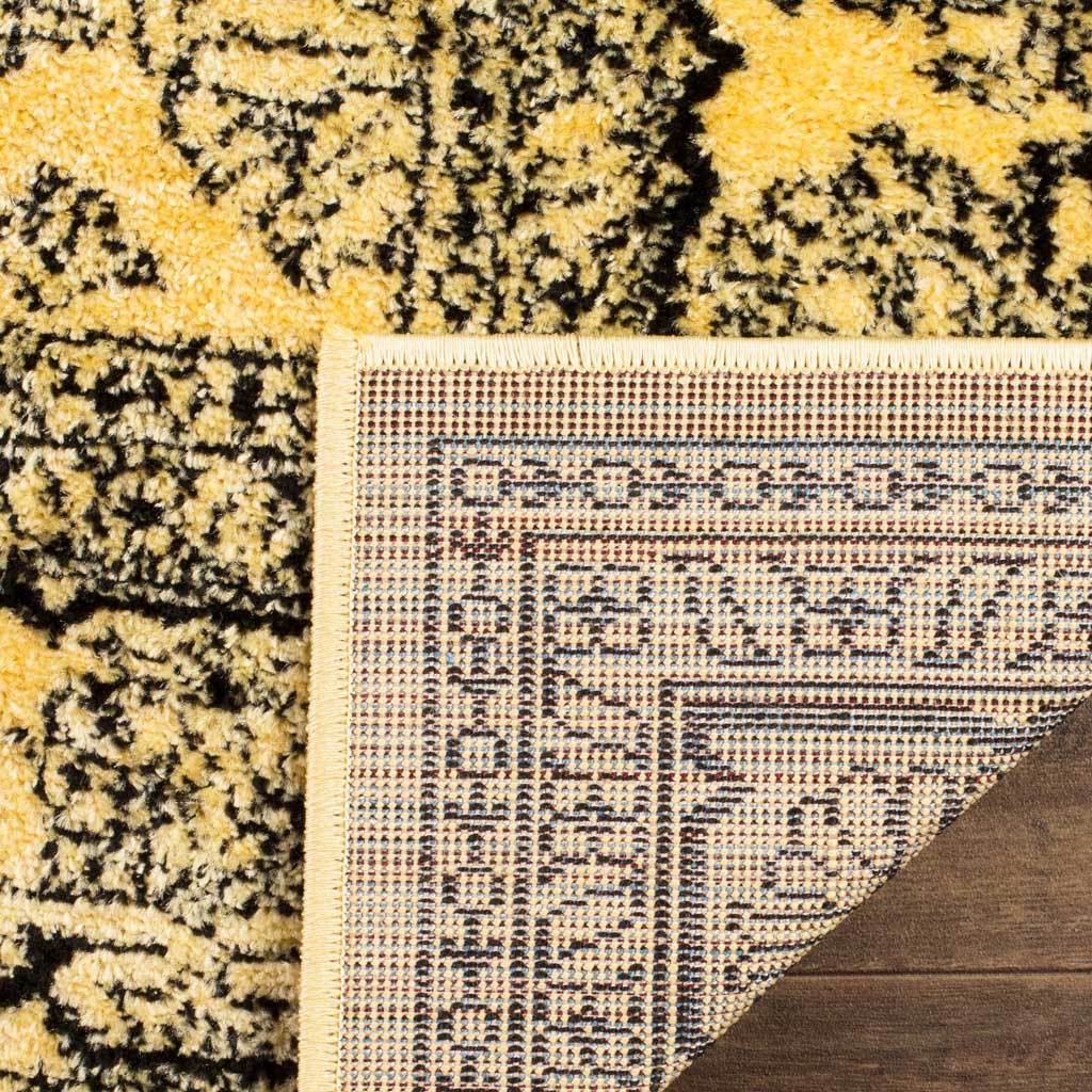 A folded corner reveals woven backing and a finished edge beneath golden pile.