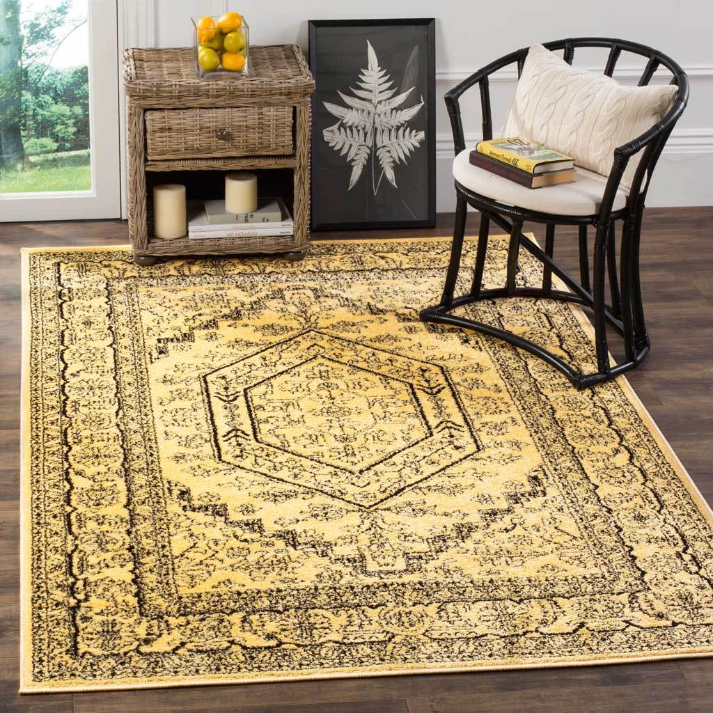 Gold and black medallion rug anchors the seating area with its richly patterned border.