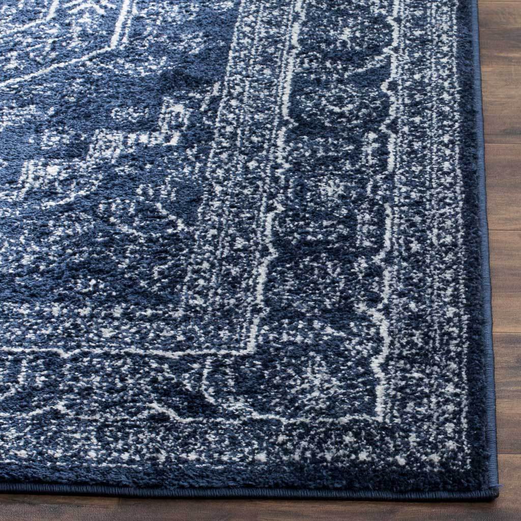 Ivory tracery accents the dark navy pile along a neatly bound floral corner.