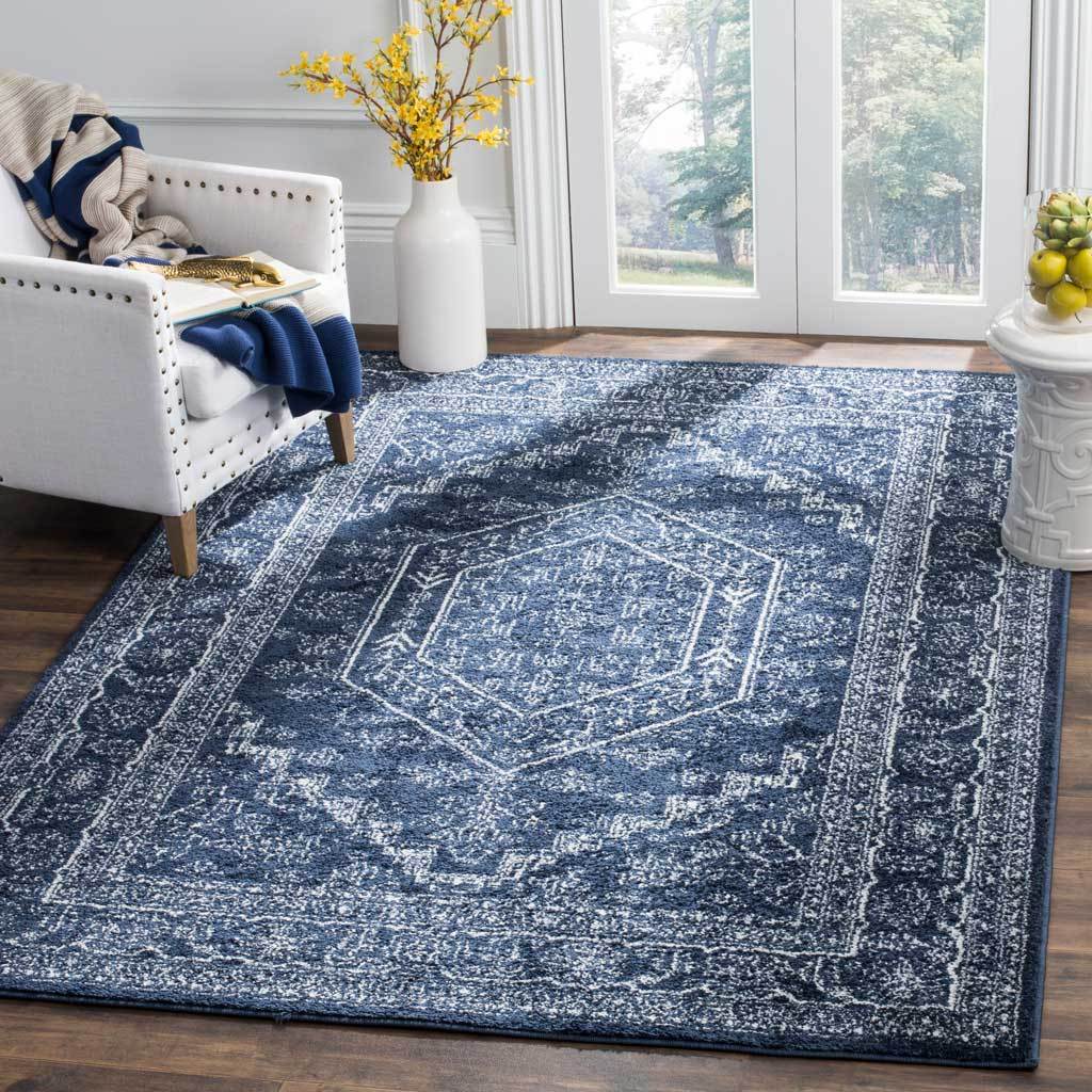 Navy and ivory medallion rug brings rich contrast and classic pattern beneath a light chair.
