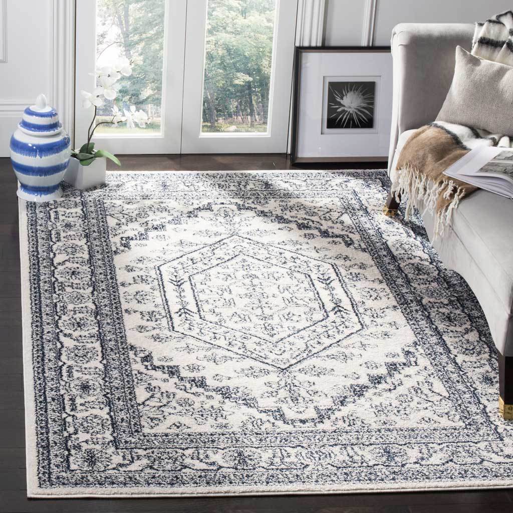 Ivory and navy floral rug brings an airy traditional medallion beneath the seating area.