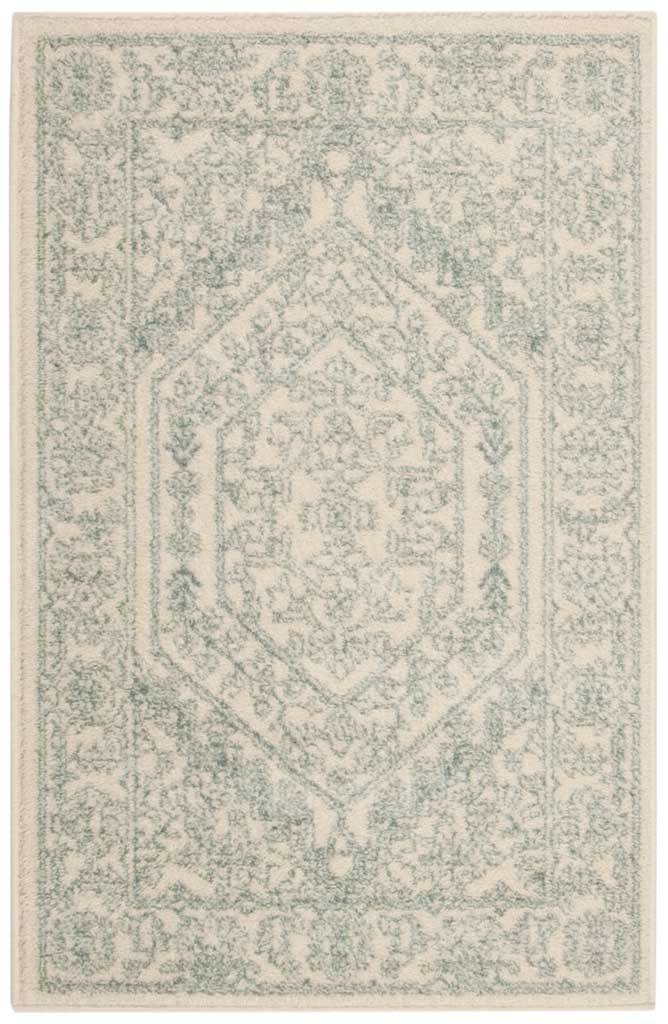 Small ivory rug shows softly washed slate patterning around a hexagonal motif.