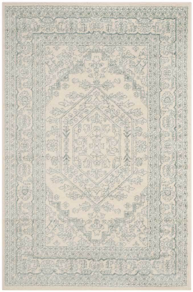 Ivory and slate rug combines a faded geometric center with delicate scrolling edges.