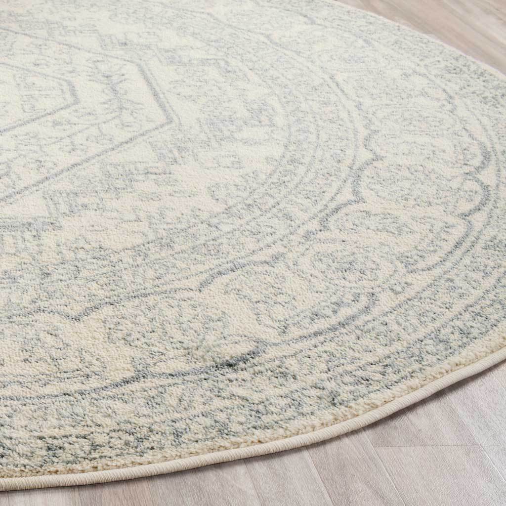Ivory pile with faded slate floral details and a neatly bound curved edge