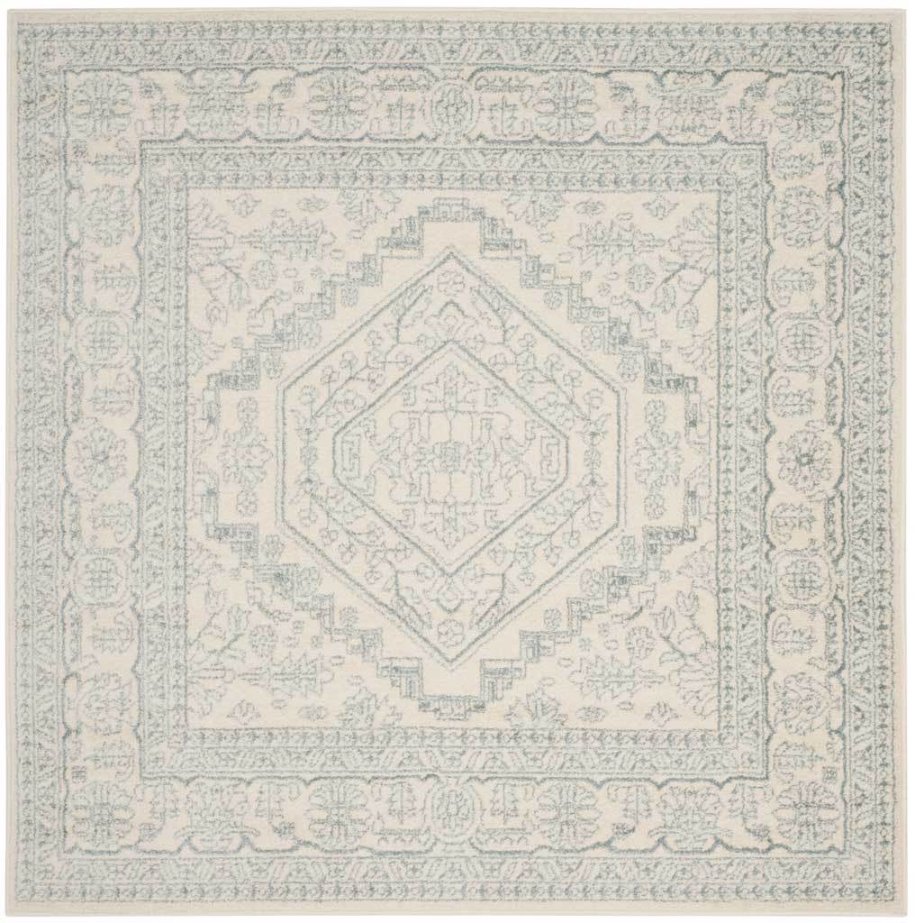Square ivory and slate rug frames a geometric medallion with ornate florals.