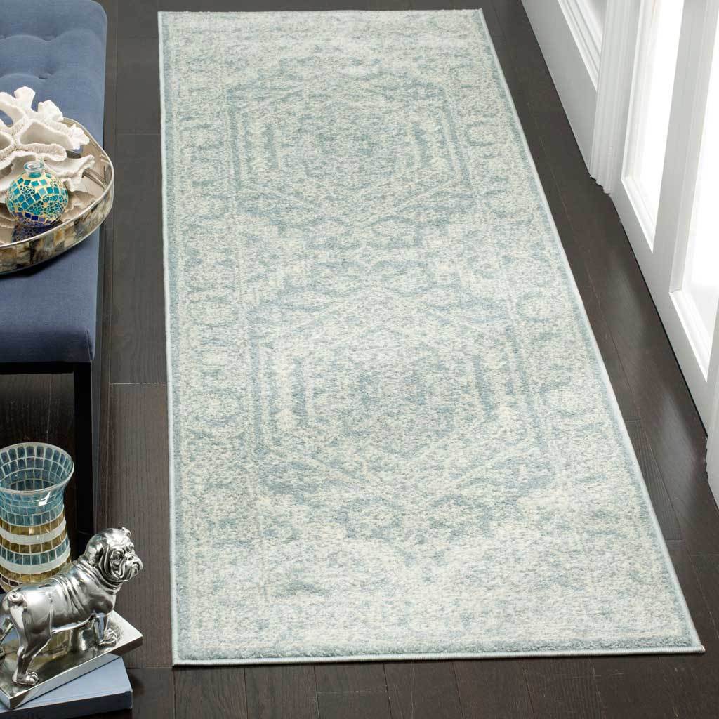 Muted slate runner with ivory scrollwork, paired medallions, and a patterned border