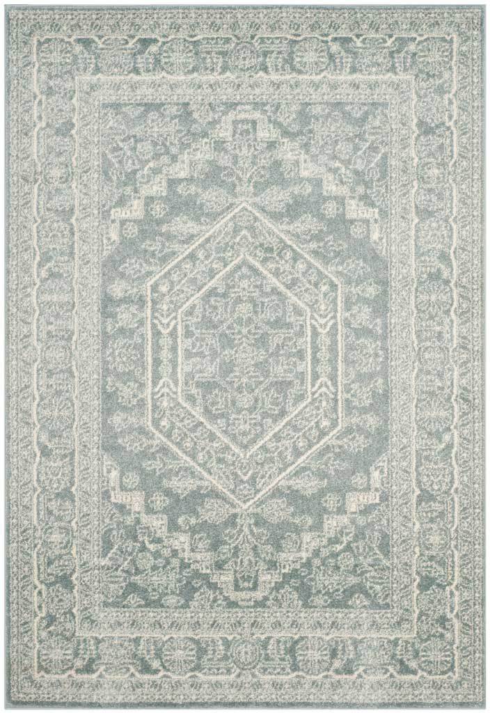 Slate area rug carries an ivory hexagonal medallion and faded floral border.