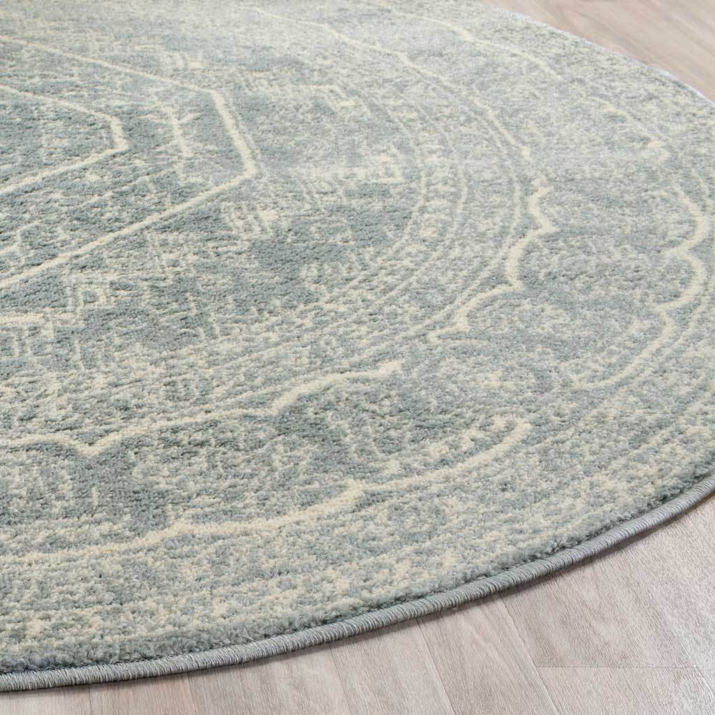Soft slate pile with ivory floral lines and a neatly finished curved edge