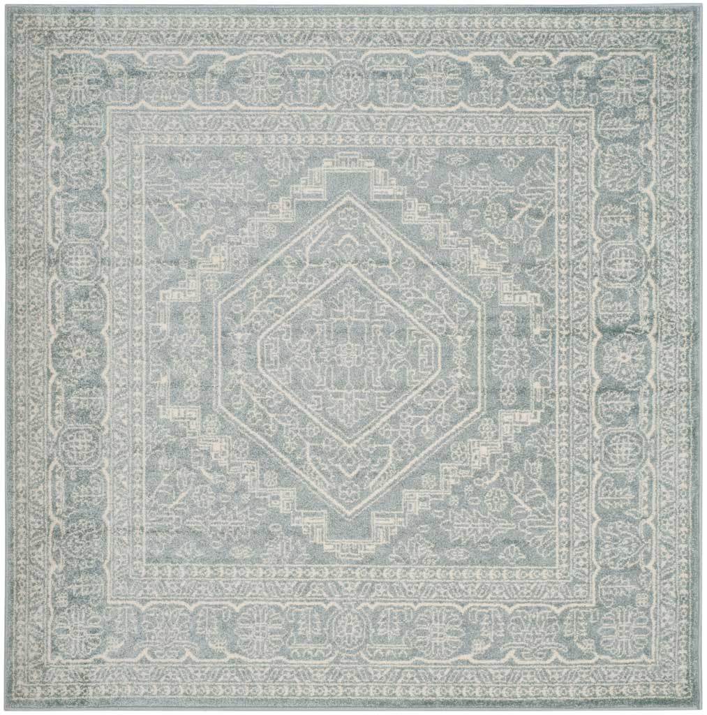 Square slate and ivory rug centers a pale medallion within ornate floral framing.