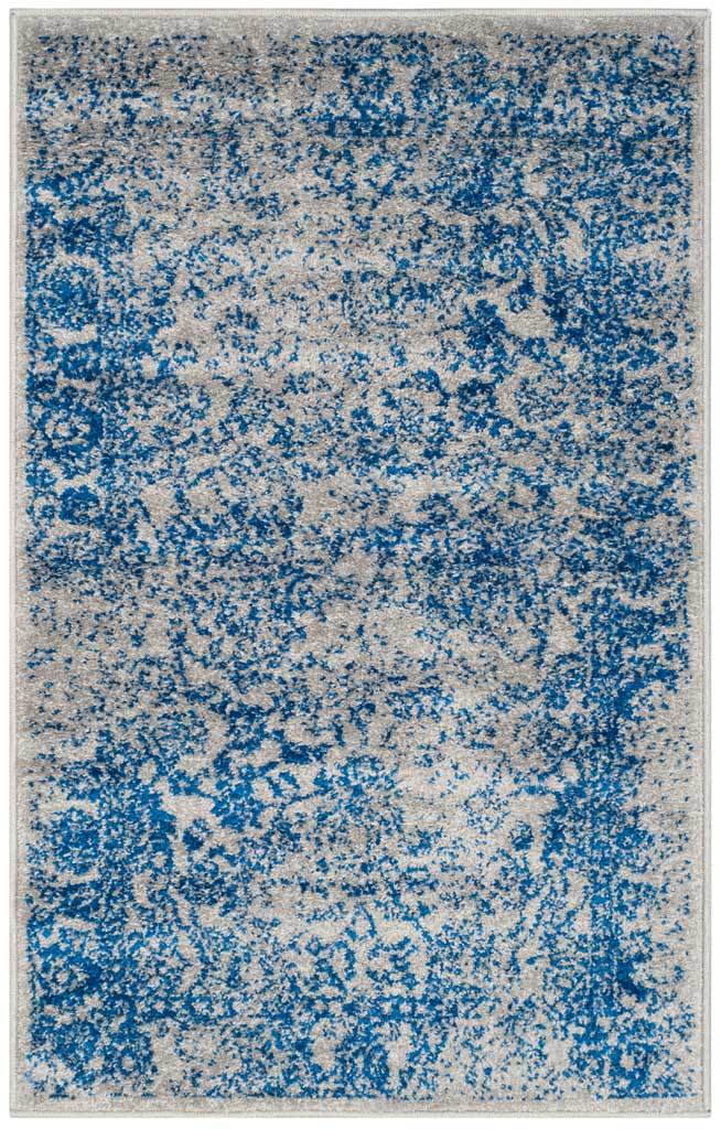 A compact gray accent rug showcases richly weathered blue floral motifs.