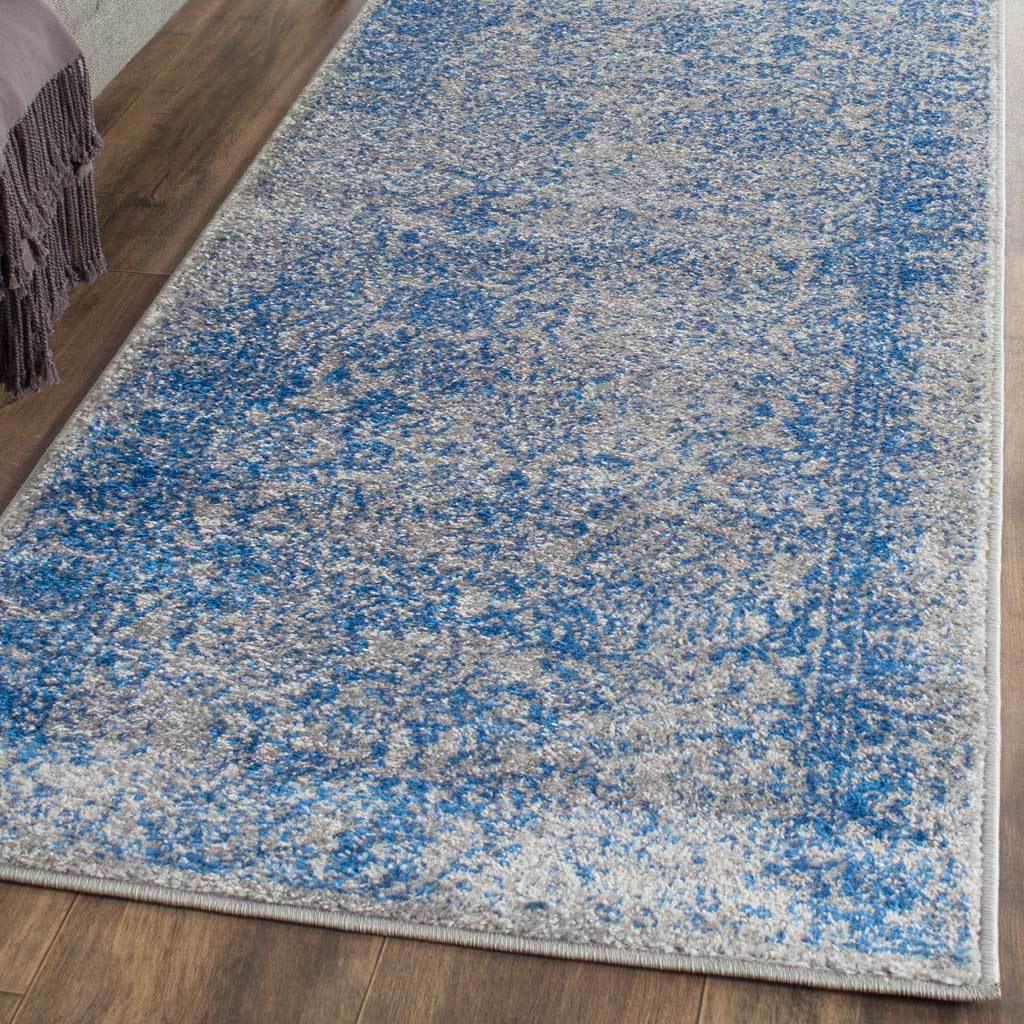 Blue and gray runner rug with vintage-inspired patterning and neatly bound edges