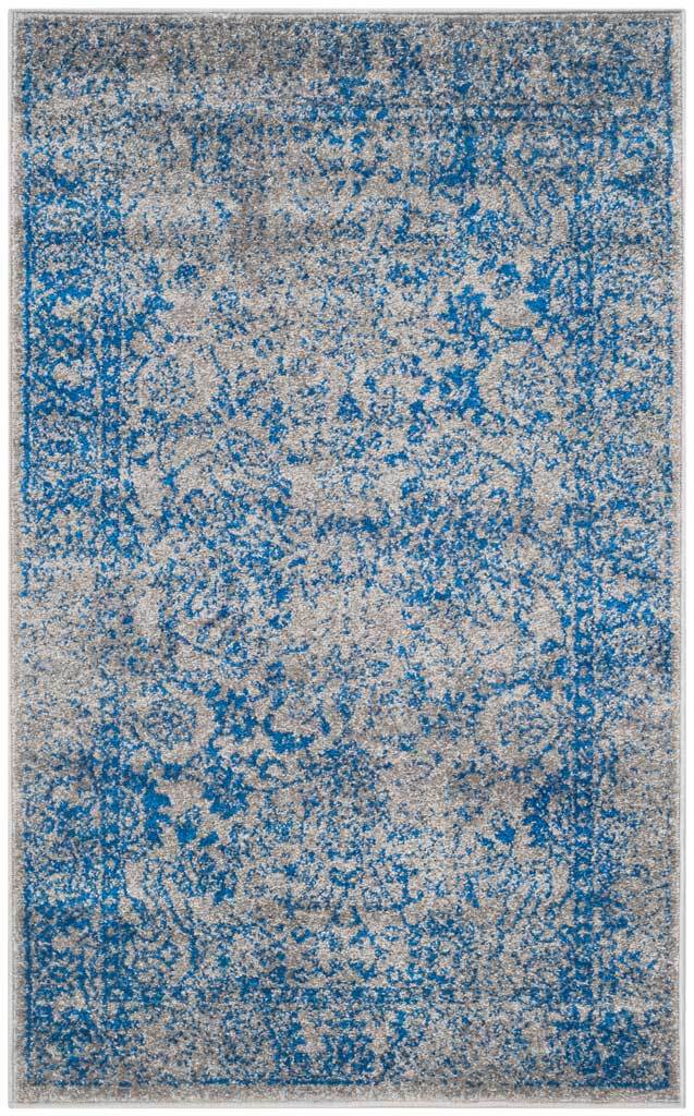 Weathered blue floral scrolls scatter over a gray field on this small rectangular rug.