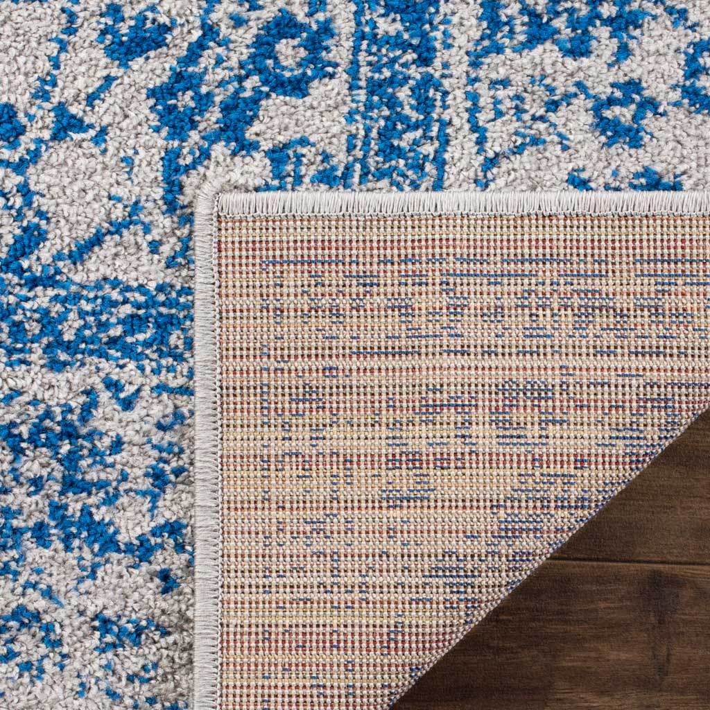 A woven reverse and tight edge binding support the blue and gray floral pile.
