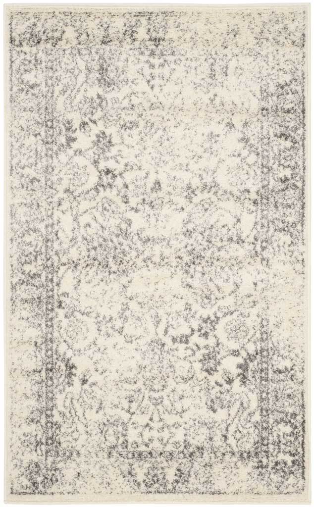 An ivory field is layered with silver-gray floral scrolls and a faded border.