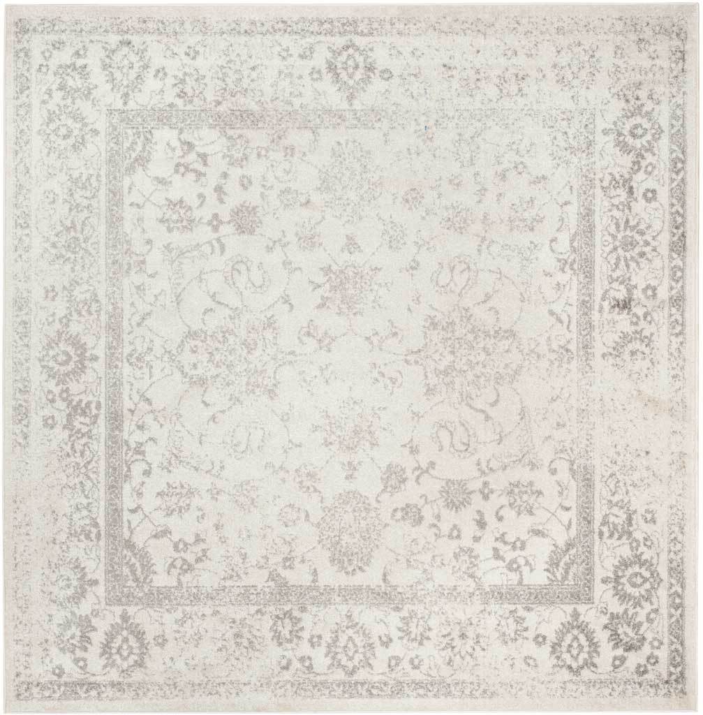 Silver botanical tracery drifts across the ivory surface of this square rug.