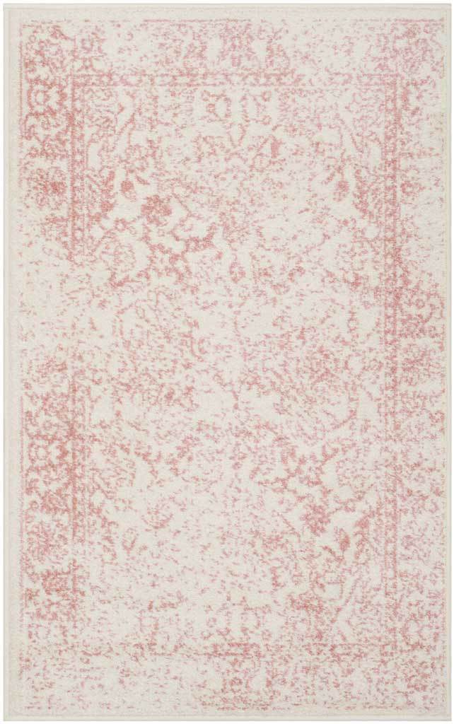 A compact ivory rug is dusted with faded rose florals and an ornate border.