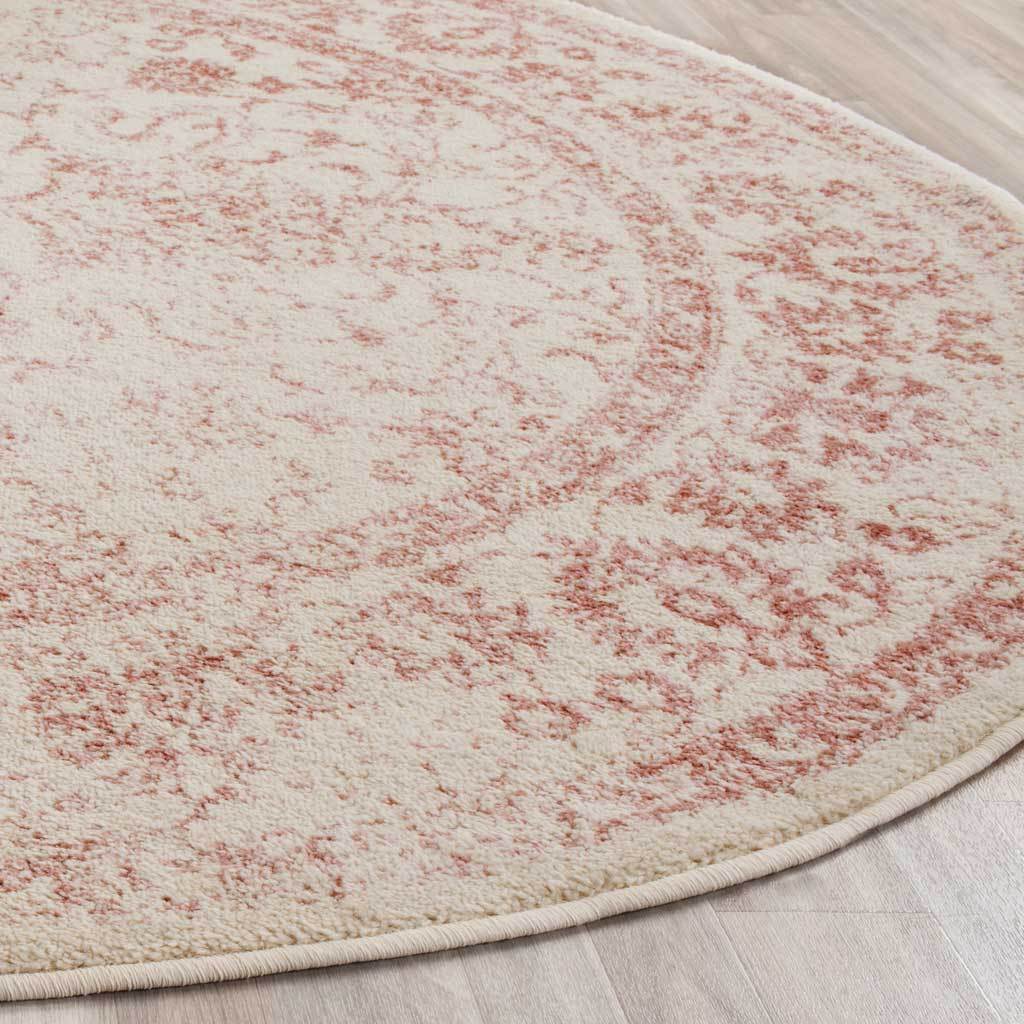 Soft ivory pile meets a rose floral border and neatly bound curved edge