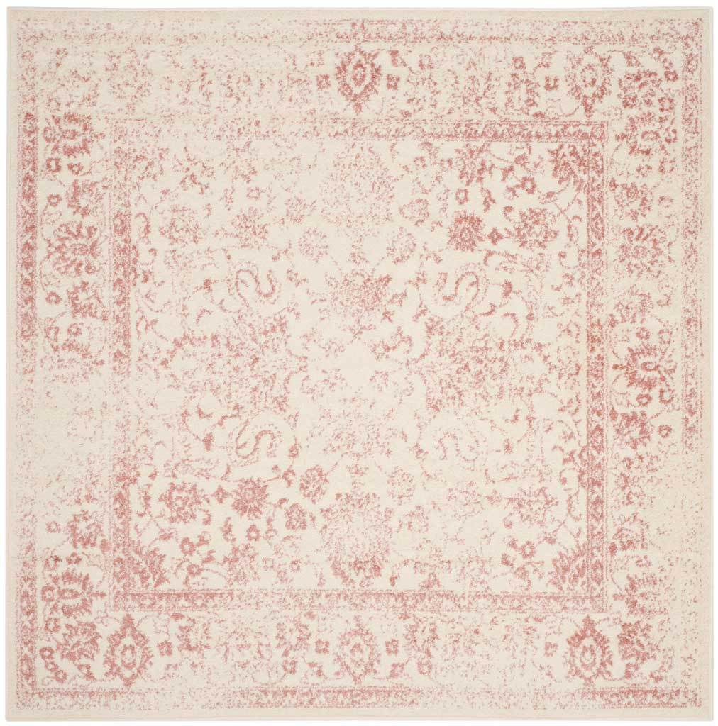An ivory square rug displays a soft rose medallion framed by floral borders.