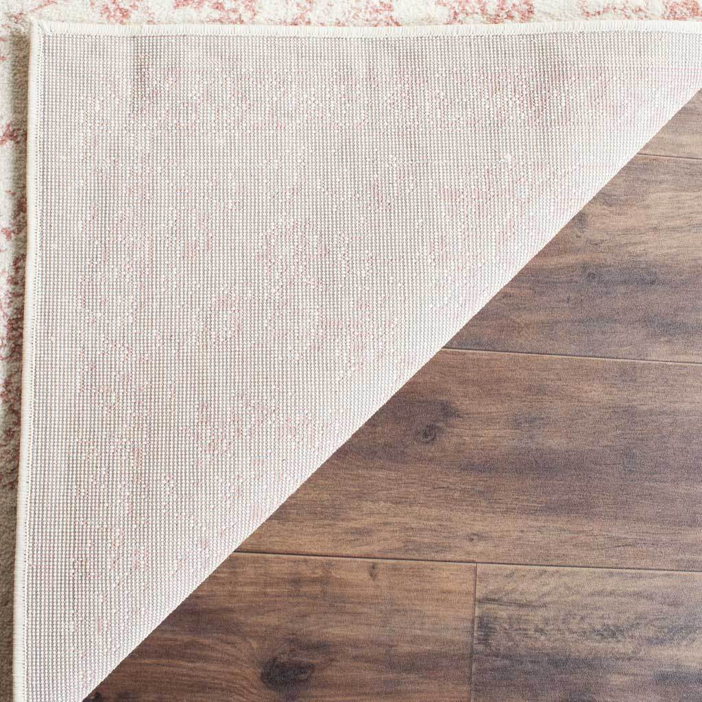 The ivory and rose rug has a woven reverse and a neatly bound edge.