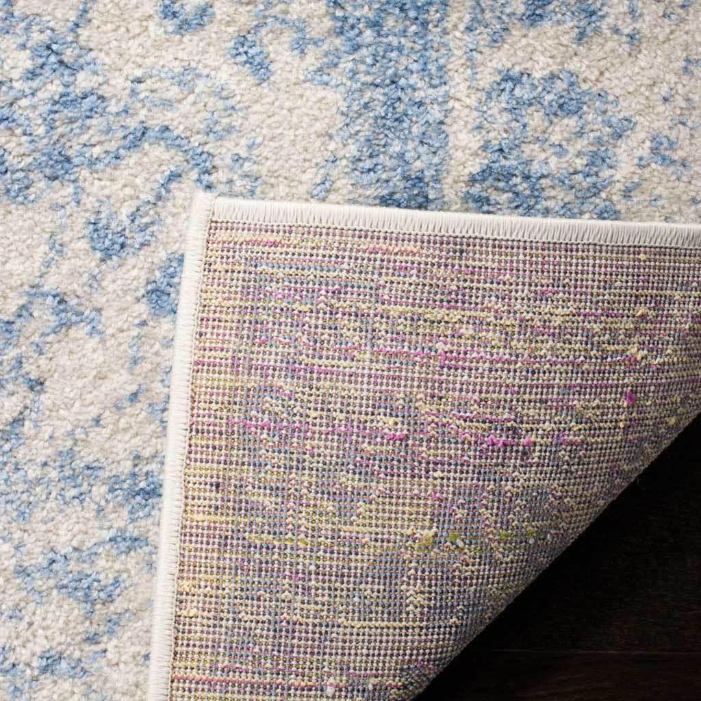 A tightly bound corner folds back to reveal woven backing beneath pale blue florals.