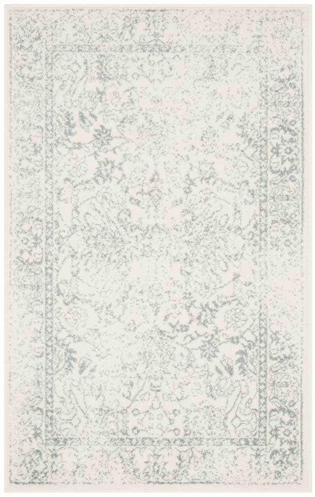 A softly worn slate border encloses airy floral motifs on ivory.