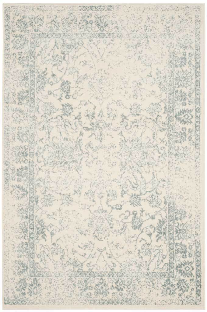 Slate botanical trails and an ornate frame enliven this ivory area rug.