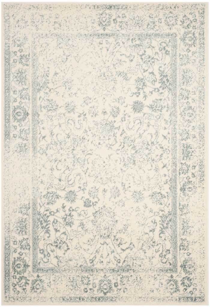 An ivory rug pairs intricate slate vines with a distressed ornamental border.