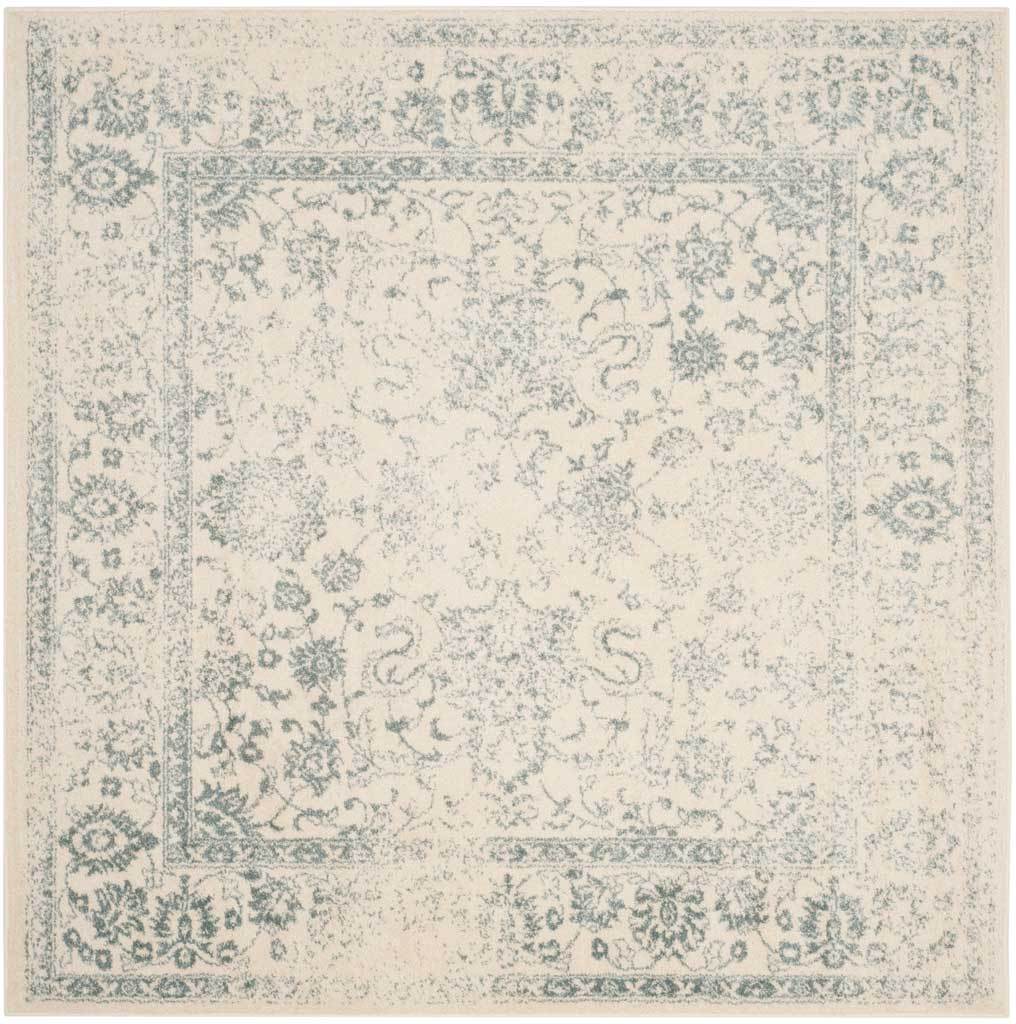 Soft slate flourishes and a classic floral border frame this square ivory rug.