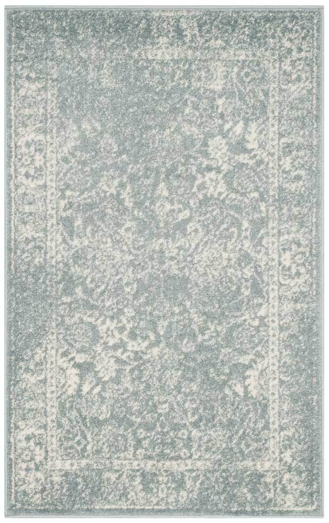 Faded ivory florals drift over the slate field of this small area rug.