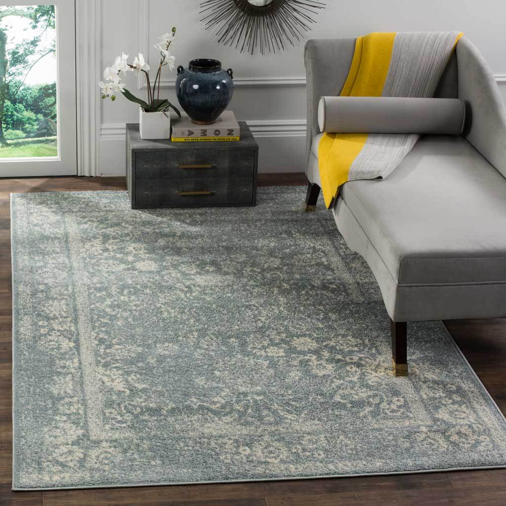 Slate and ivory florals create a rich backdrop for a gray lounge chair.