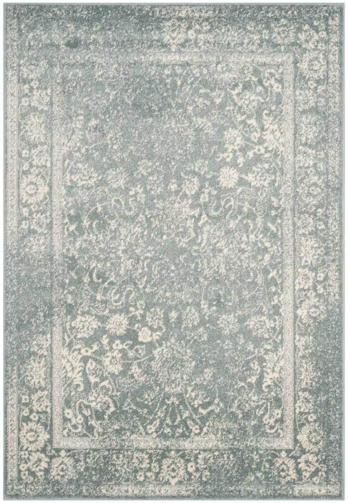 A slate rug features airy ivory vines and an intricate floral frame.