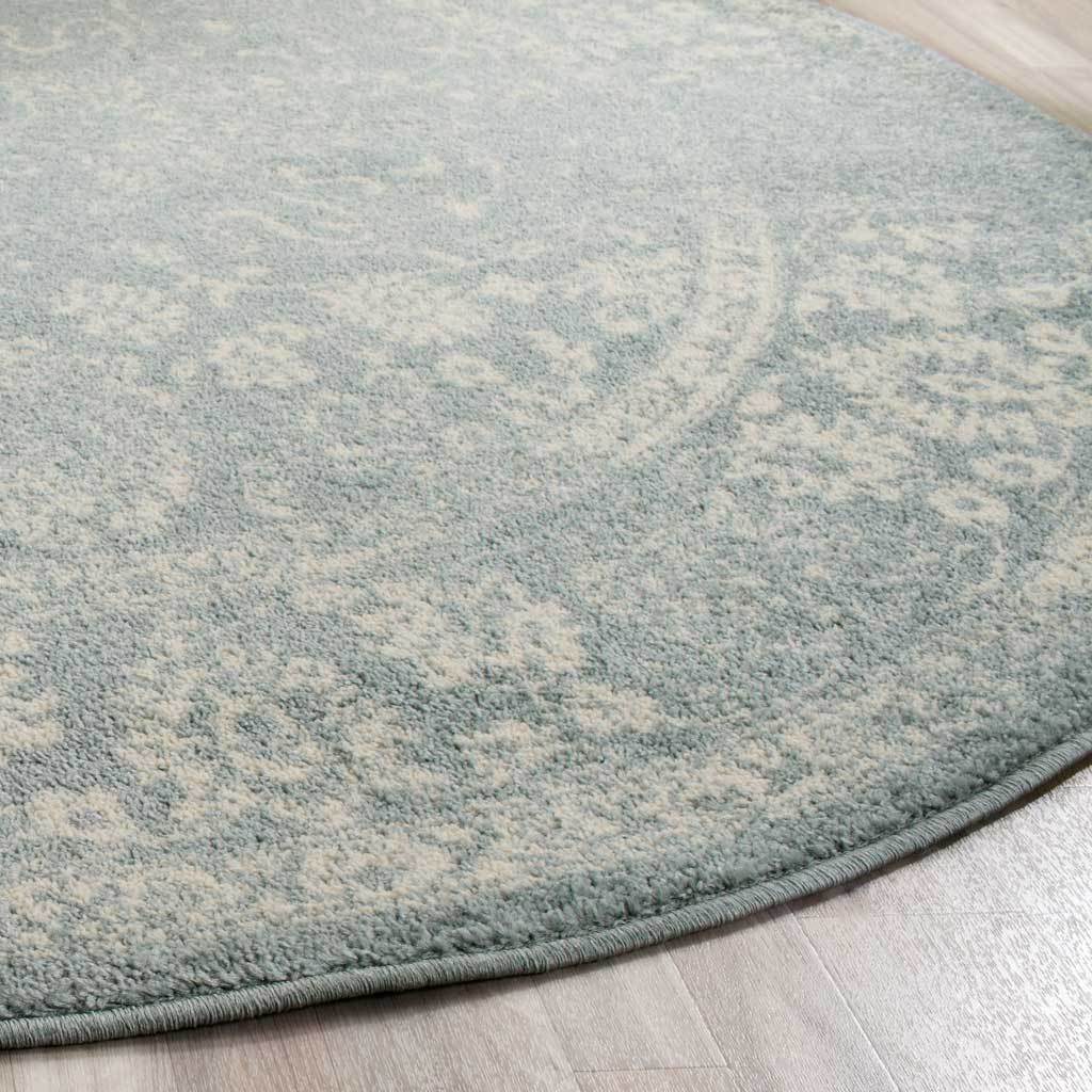 Ivory floral accents emerge from slate-colored pile near the bound edge